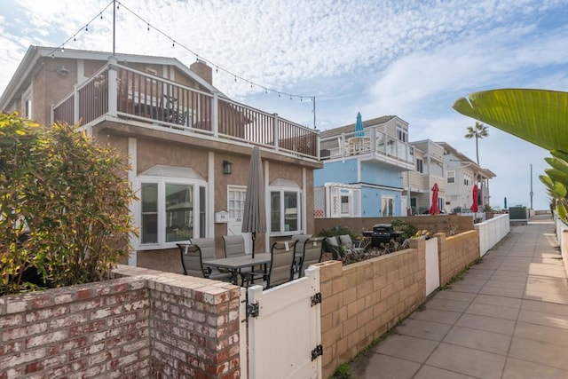 exterior space featuring a balcony and a patio