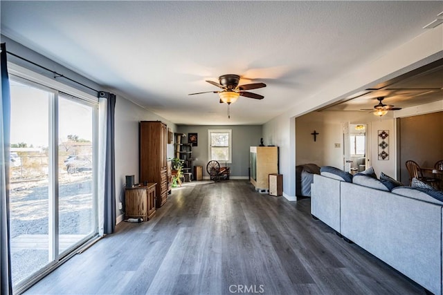 unfurnished living room featuring ceiling fan and dark hardwood / wood-style floors