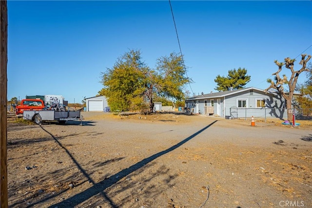 view of yard with an outdoor structure and a garage