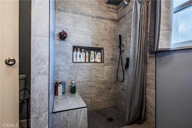 bathroom featuring toilet and a shower with curtain