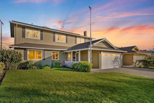 front of property featuring a garage and a yard