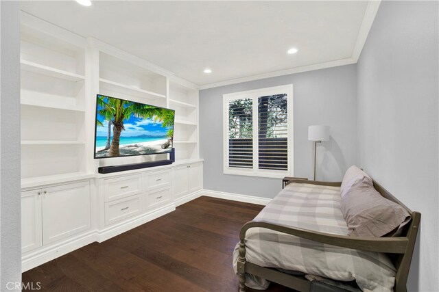 sitting room featuring crown molding, built in features, and dark hardwood / wood-style floors