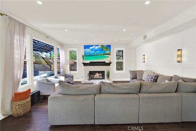 living room featuring a fireplace and dark hardwood / wood-style flooring