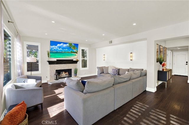 living room featuring a fireplace and dark wood-type flooring