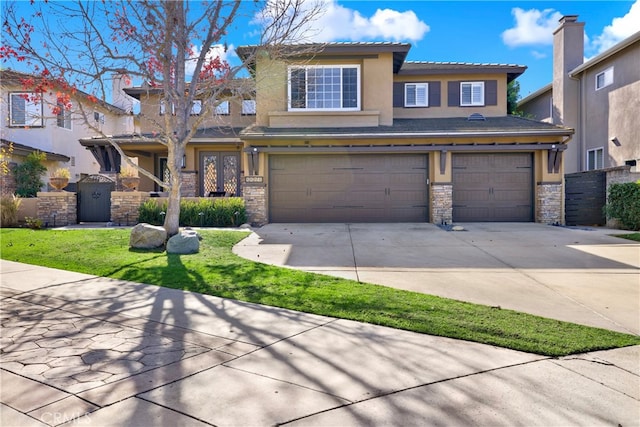 view of front of property with a front yard and a garage