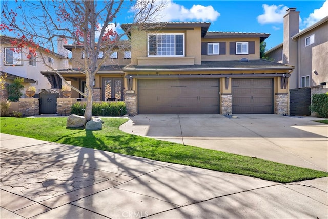 view of front of home featuring driveway, an attached garage, and stucco siding