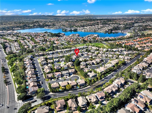 drone / aerial view with a water view and a residential view