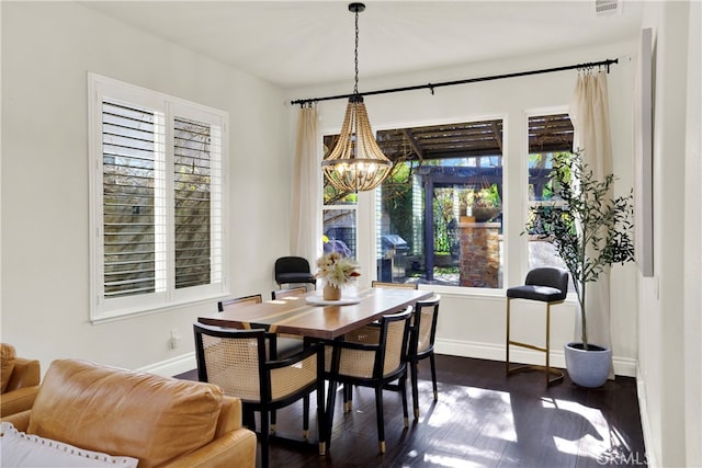 dining space featuring a chandelier and dark hardwood / wood-style flooring