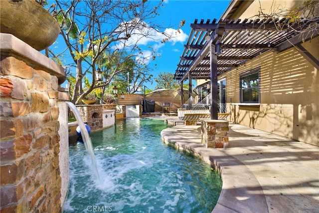 view of swimming pool featuring pool water feature, a patio, and a pergola