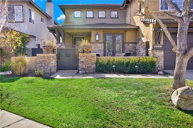 view of front facade with a front lawn and french doors