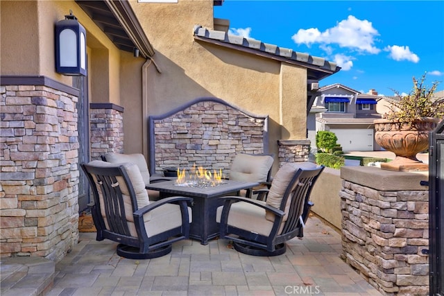 view of patio / terrace featuring an outdoor stone fireplace