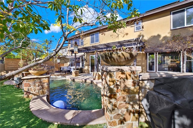 pool featuring a patio area, a grill, fence, and a yard