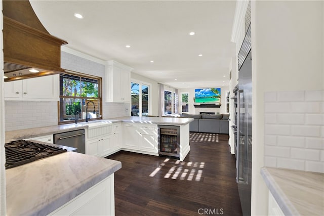 kitchen featuring wine cooler, a healthy amount of sunlight, dishwasher, and custom exhaust hood