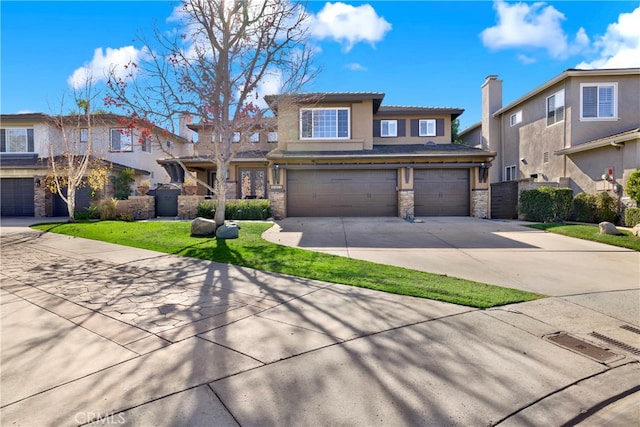 view of front of house featuring a garage, concrete driveway, stone siding, stucco siding, and a front yard