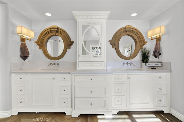 full bathroom featuring double vanity, a sink, and recessed lighting