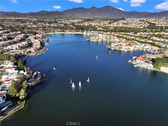 birds eye view of property featuring a water and mountain view