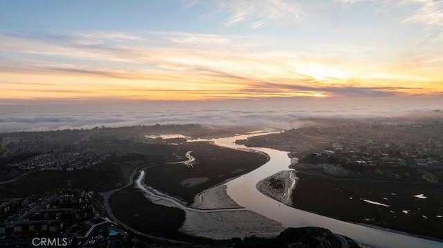 aerial view at dusk with a water view