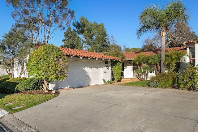 mediterranean / spanish home with a garage