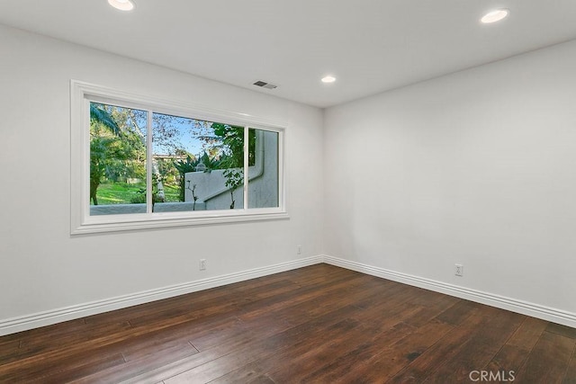 spare room with dark hardwood / wood-style flooring