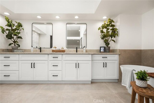 bathroom with a tub to relax in and vanity