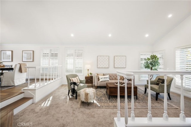 living room with lofted ceiling, light carpet, and crown molding