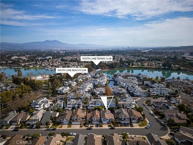 drone / aerial view with a water and mountain view