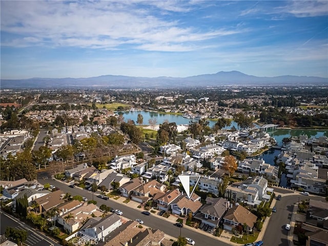 drone / aerial view featuring a water and mountain view