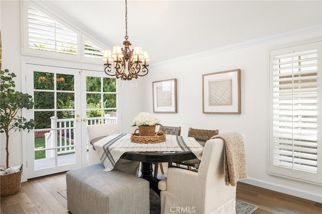 dining room with hardwood / wood-style flooring, an inviting chandelier, and plenty of natural light