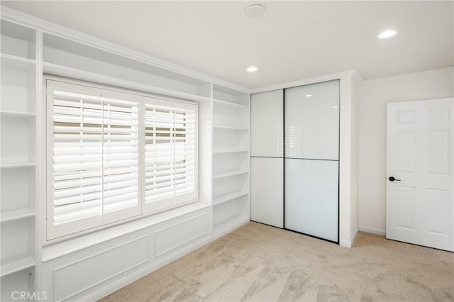 spacious closet featuring light colored carpet