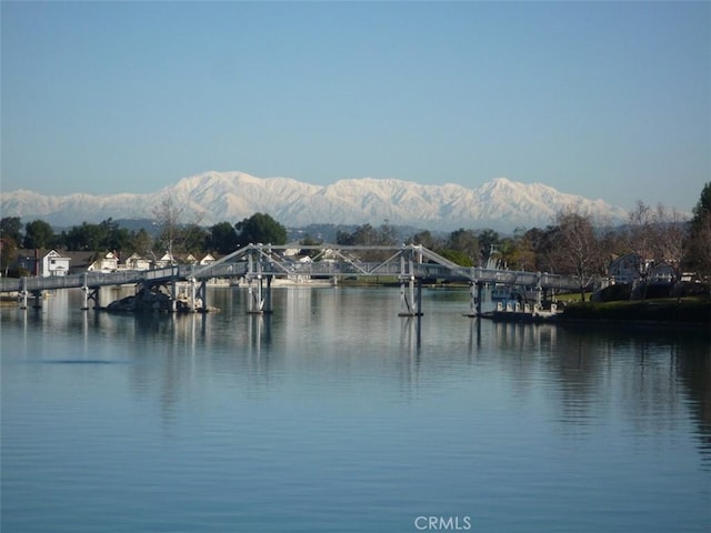 property view of water featuring a mountain view and a boat dock