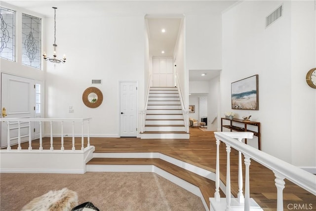 interior space featuring an inviting chandelier and a high ceiling