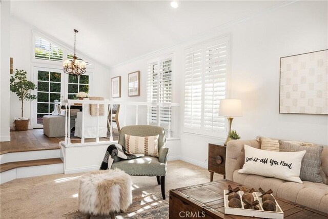 interior space featuring a notable chandelier, lofted ceiling, french doors, carpet flooring, and crown molding