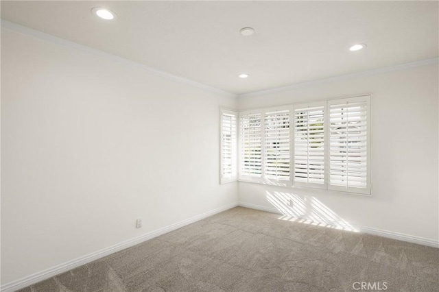 carpeted empty room featuring crown molding