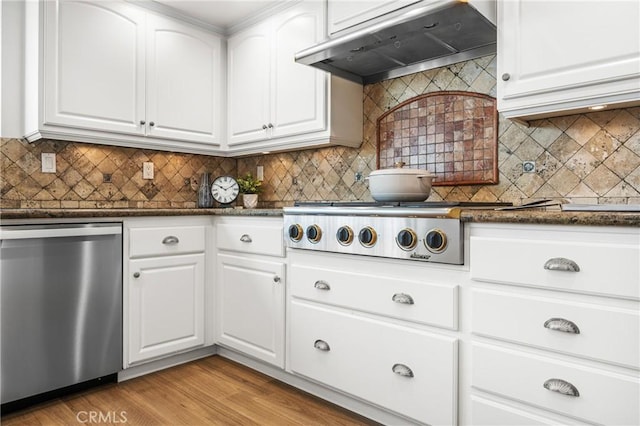 kitchen featuring tasteful backsplash, ventilation hood, appliances with stainless steel finishes, and white cabinetry