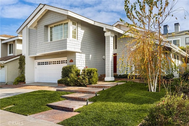 view of front of property with a front yard and a garage