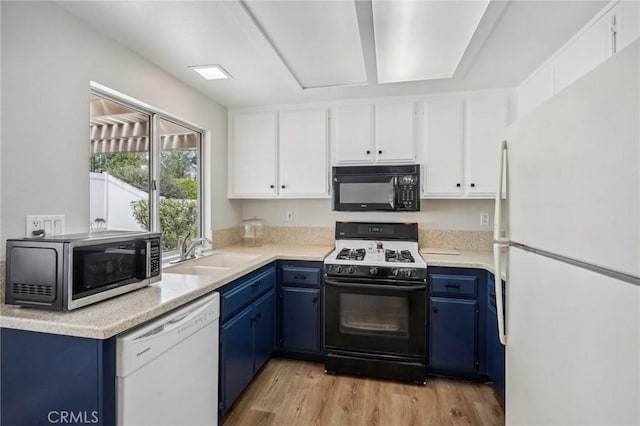 kitchen with blue cabinets, white appliances, white cabinetry, and a sink