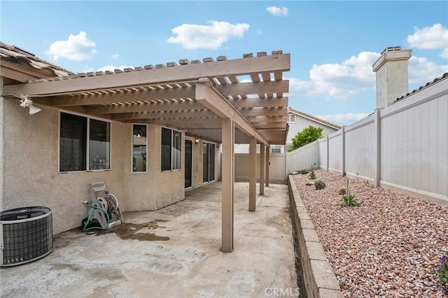 view of patio featuring central AC unit, a fenced backyard, and a pergola