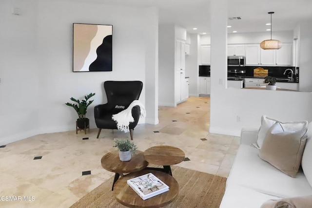 tiled living room featuring sink