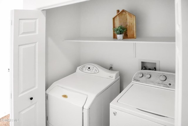 clothes washing area featuring separate washer and dryer