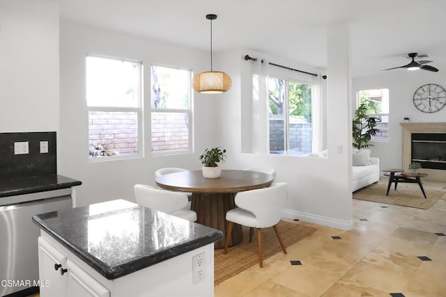 tiled dining area with ceiling fan