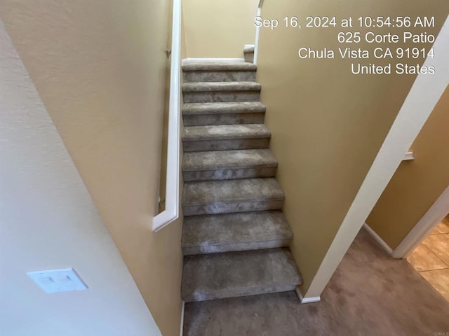 stairway with tile patterned floors