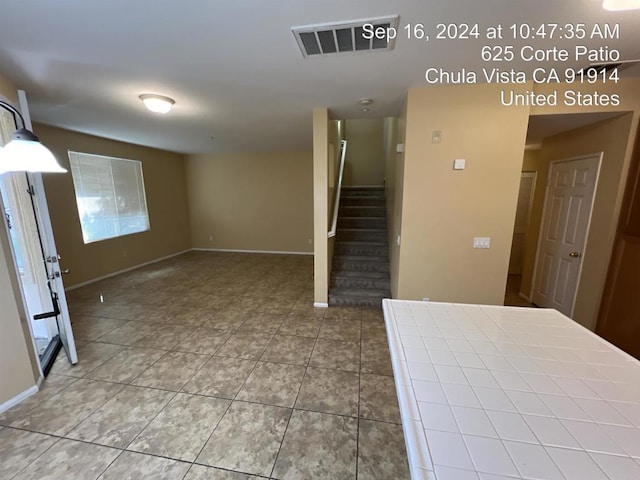 stairway with tile patterned flooring