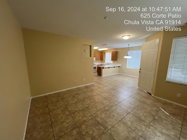 unfurnished living room with light tile patterned floors