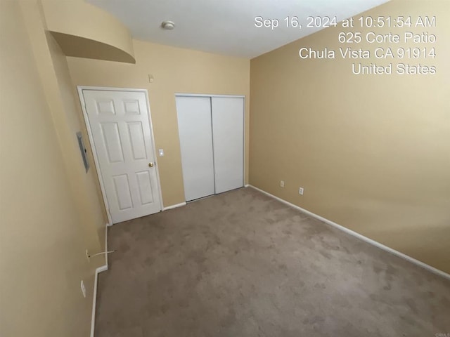 unfurnished bedroom with carpet floors and a closet