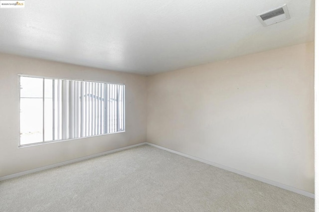 spare room with light colored carpet