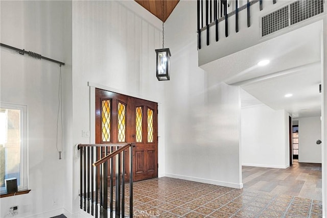 foyer entrance with a high ceiling