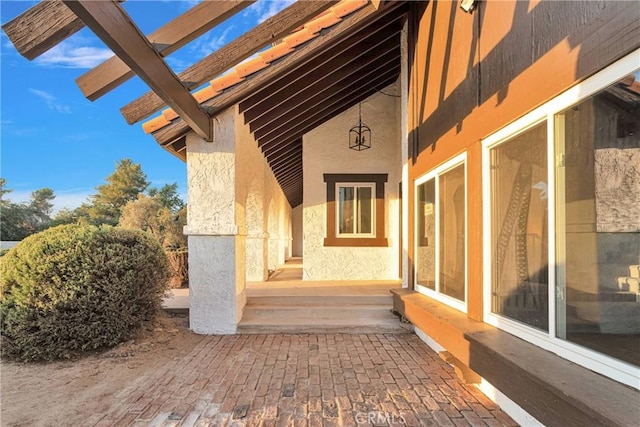 view of side of home featuring a pergola and a patio