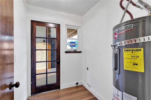 interior space with water heater and wood-type flooring