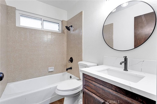 full bathroom featuring toilet, vanity, and tiled shower / bath