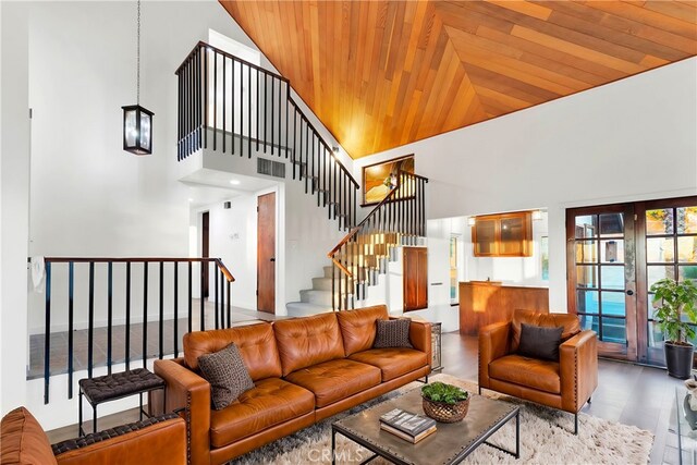 living room featuring wood ceiling, high vaulted ceiling, french doors, and wood-type flooring